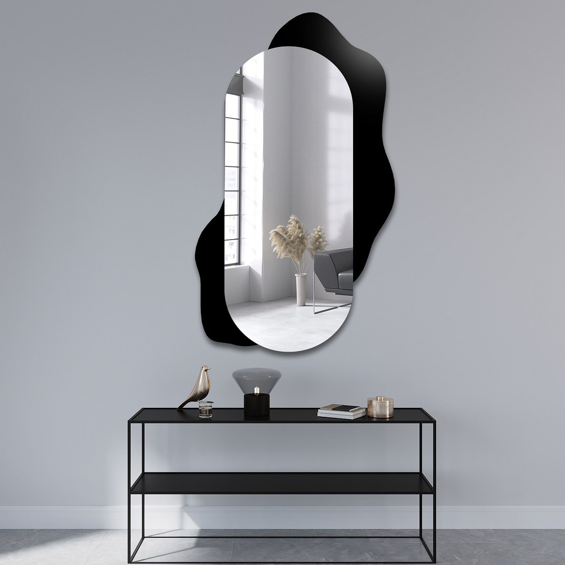 Miroir ovale avec un cadre noir ondulé fixé au mur, apportant une touche sophistiquée et contemporaine à la décoration intérieure.